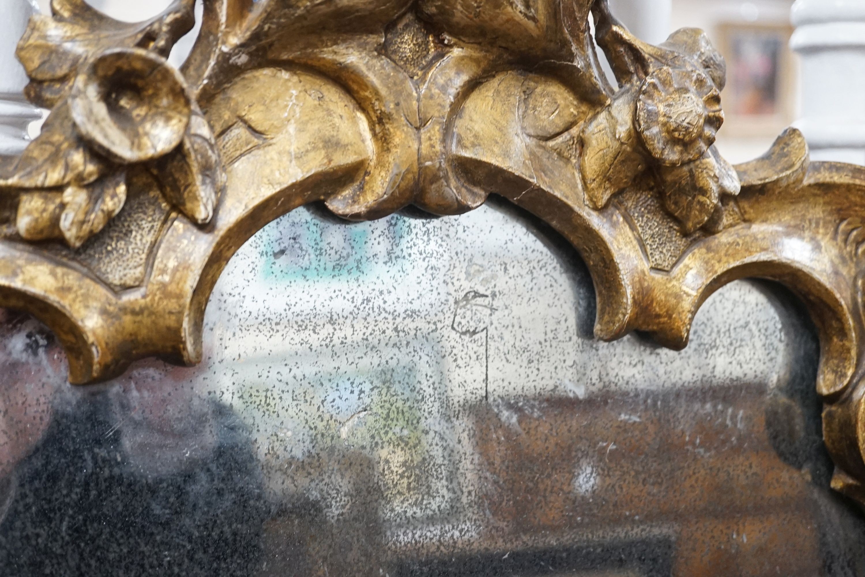 An 18th century Italian carved giltwood cartouche wall mirror, width 53cm, height 76cm
